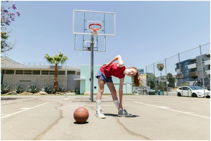 Teen girl bends and stretches during a workout on