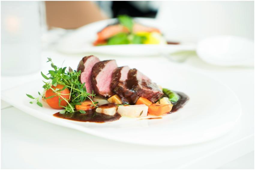 Elegant presentation of sliced beef with herbs and