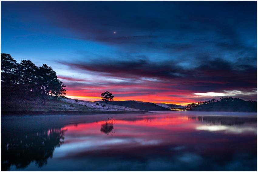 Stunning sunset reflecting over a calm river with