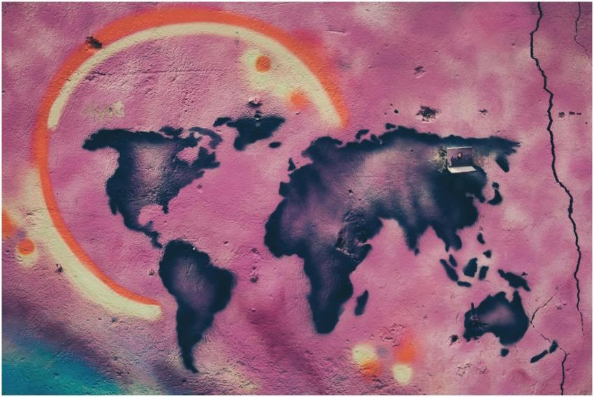 Colorful graffiti art depicting a world map on a c