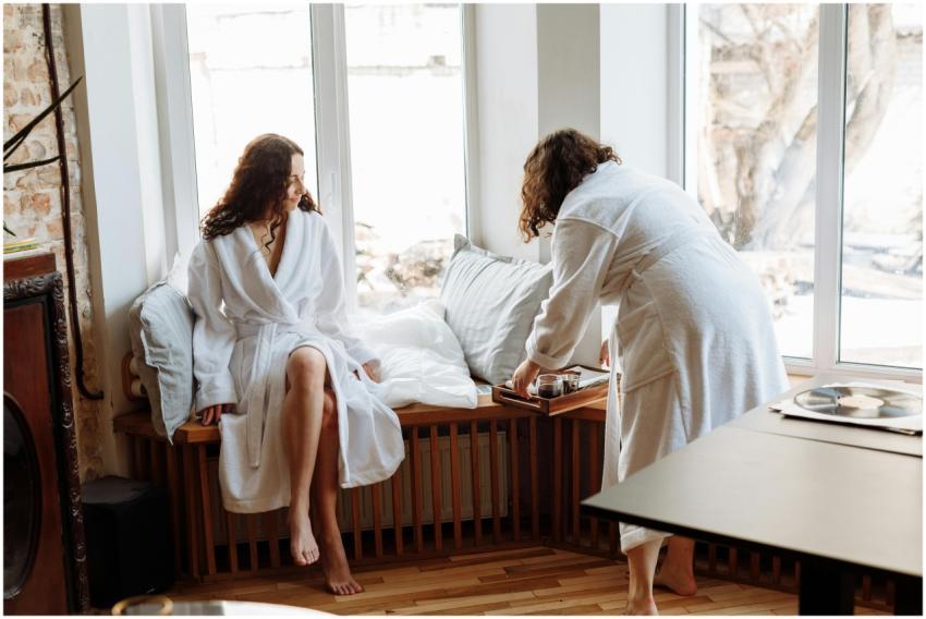 Two women in bathrobes sharing a leisurely morning