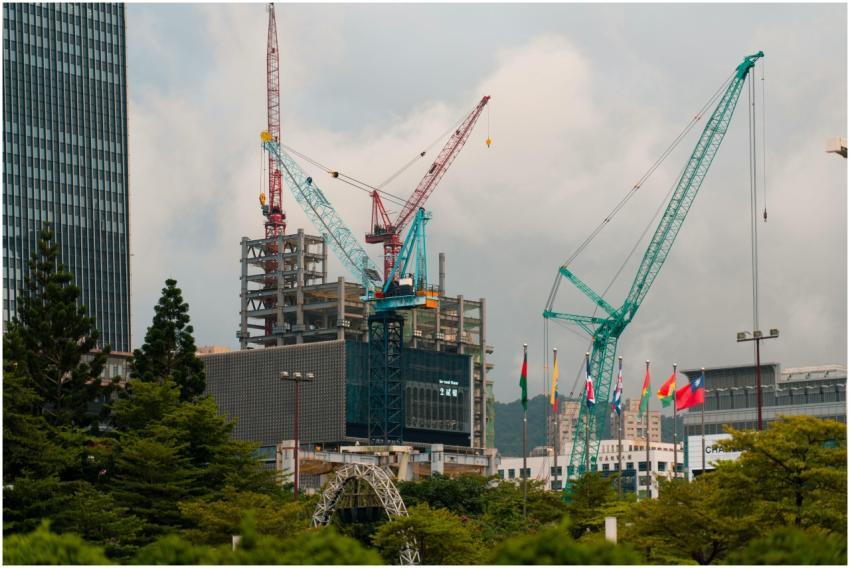 Cranes tower over a construction site amidst Taipe