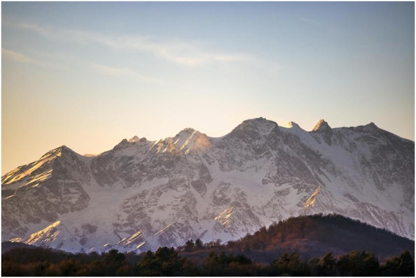 A stunning view of a snow-capped mountain range ba