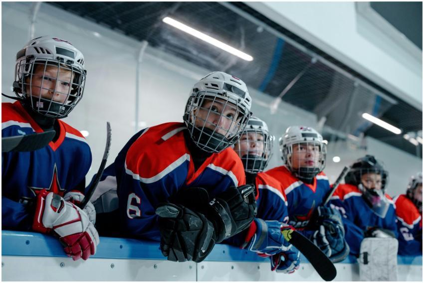 Energetic youth ice hockey team in blue and red un