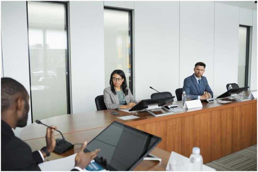 Professionals engaging in a meeting in a bright, m
