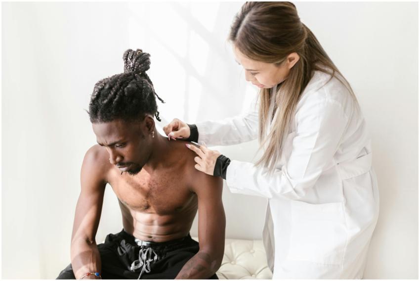 A therapist performs acupuncture on a patient for