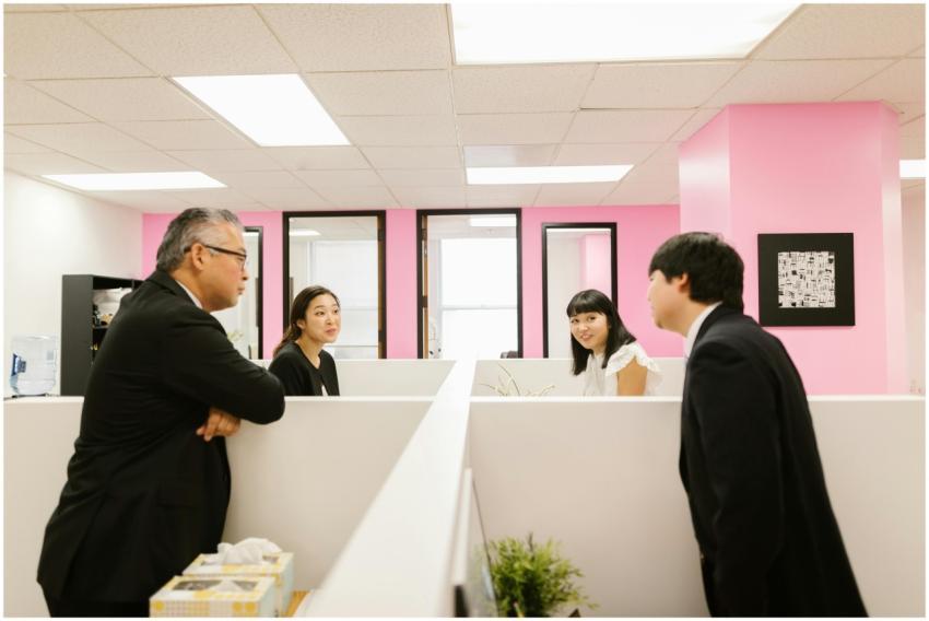 A group of Asian colleagues engaged in a lively di