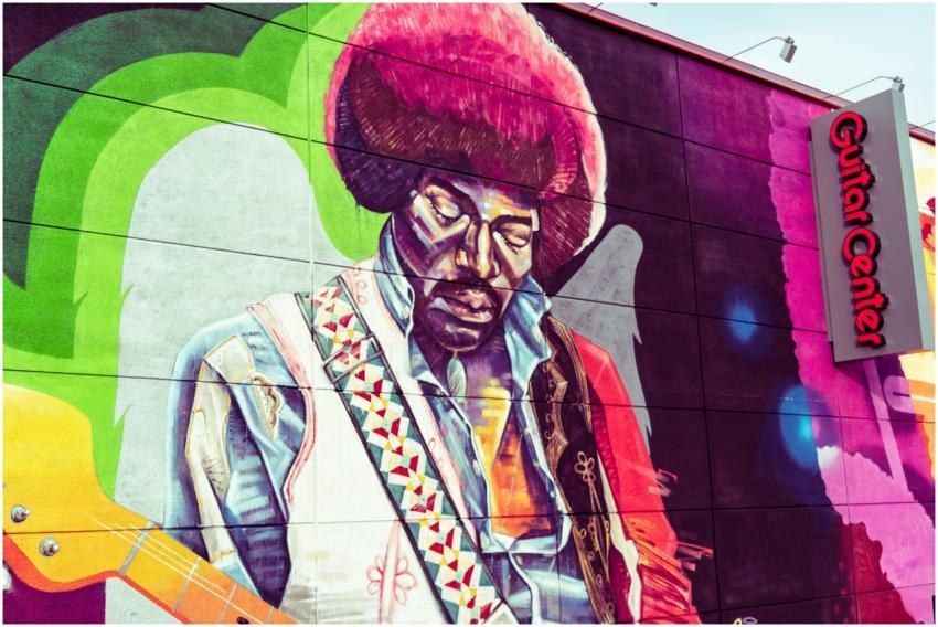 Colorful street art mural of a music legend painte