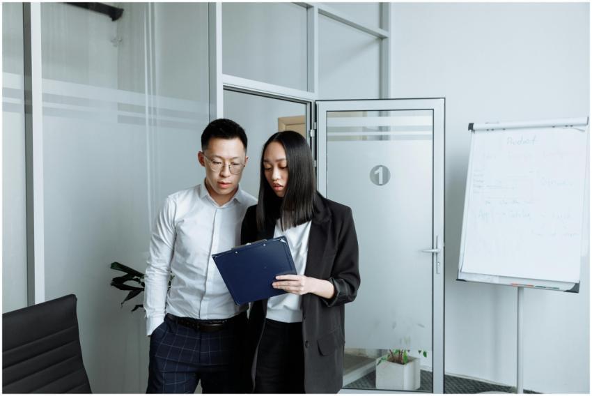 Two business professionals reviewing documents in