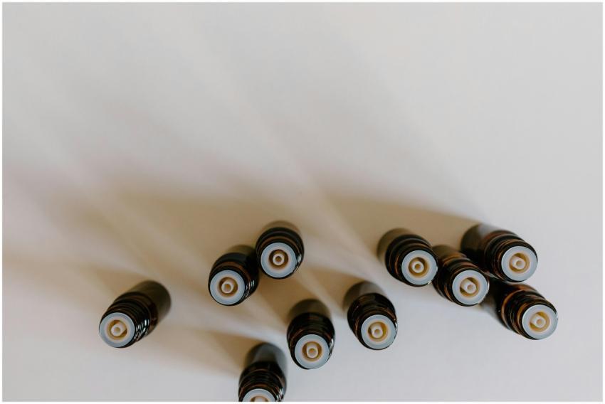 Top view of brown essential oil bottles on white b