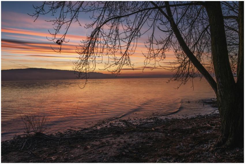 Peaceful lakeside sunset with vivid sky reflection