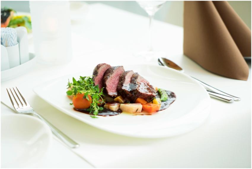 A beautifully presented beef steak with vegetables