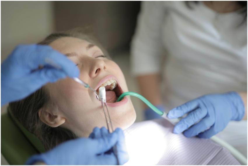 Dentist examines a patient using tools in a clinic
