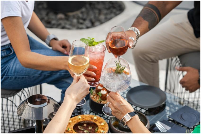 Group of friends enjoying drinks and food outdoors