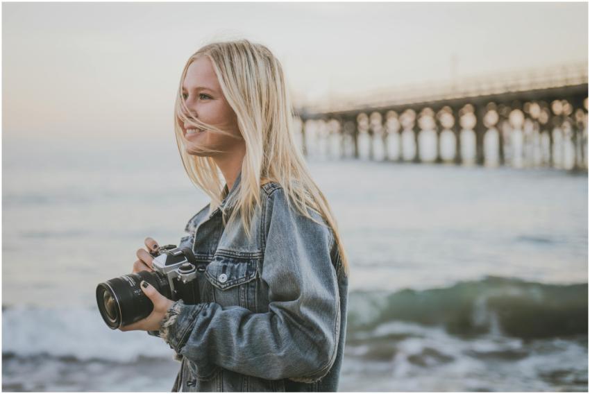 A young photographer captures the serene beach vib