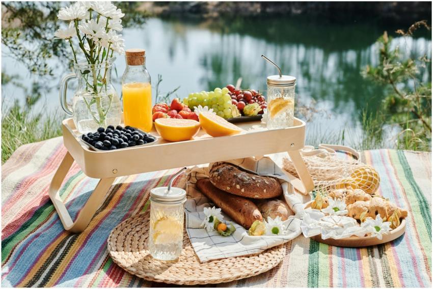 A colorful picnic setup with fresh fruits, bread,