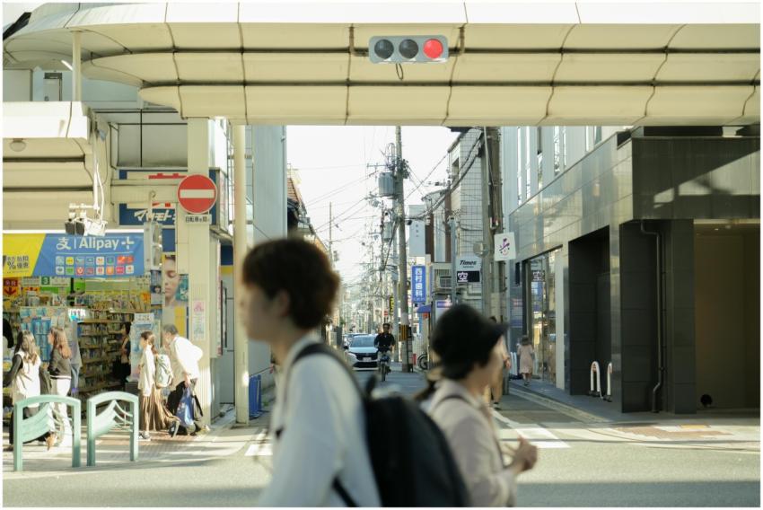 Busy street scene in Japan with pedestrians, shops