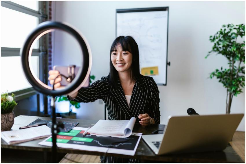 A woman vlogger uses her smartphone to create cont