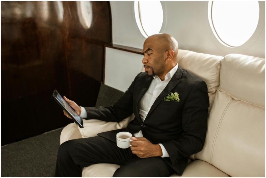 Businessman in formal attire holding tablet and co