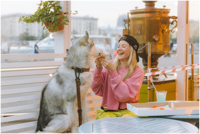 A joyful moment of a woman sharing pizza with her