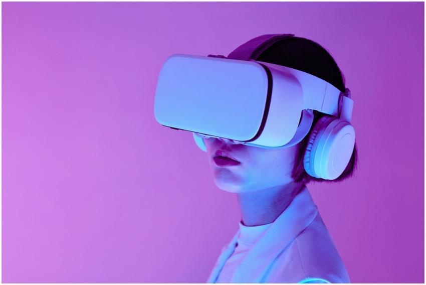 Woman explores virtual reality with VR goggles in