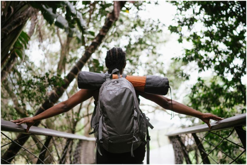 A woman with a backpack enjoys a scenic hike on a