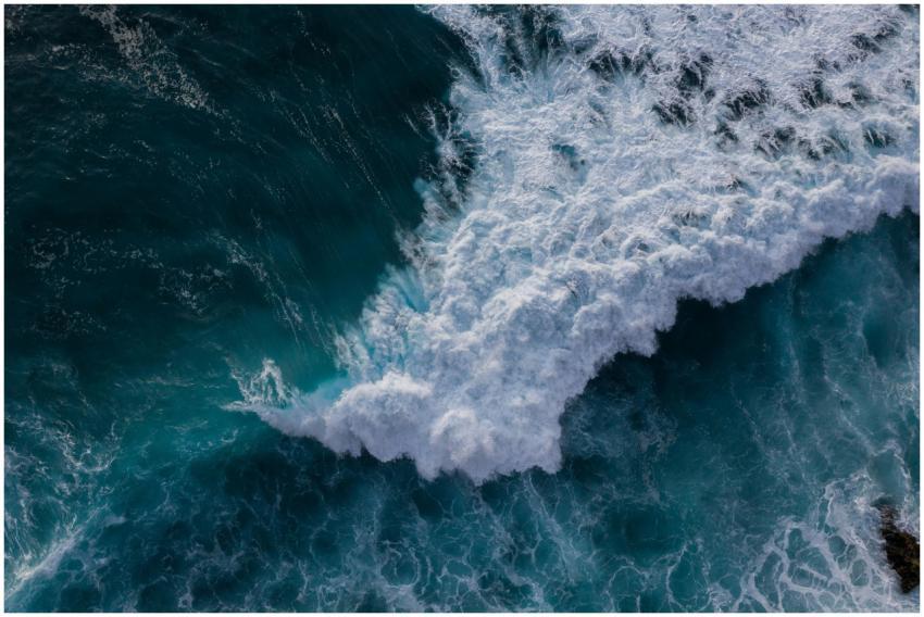 Aerial view of powerful ocean waves crashing again