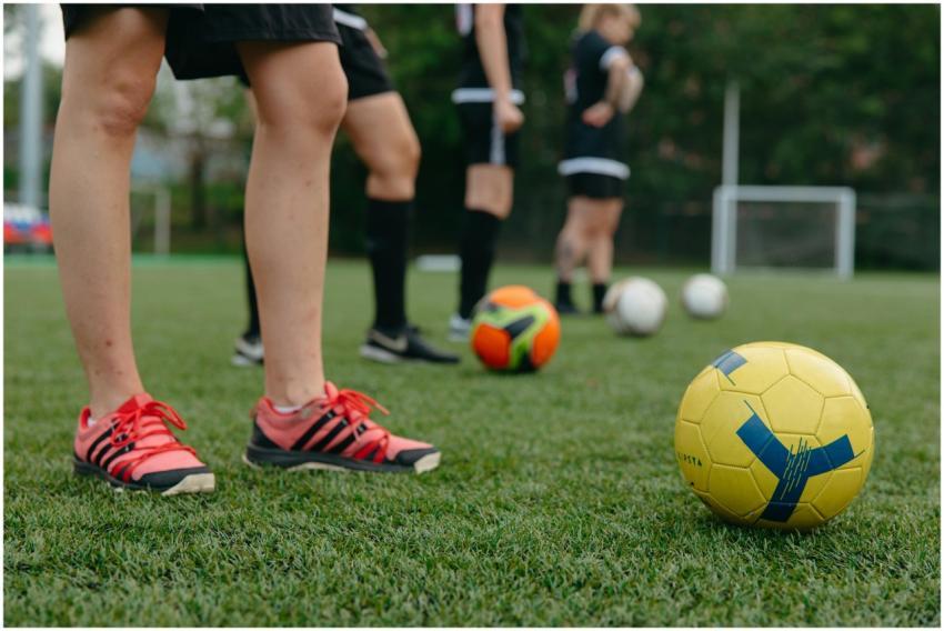 Close-up of soccer players on a grass field with c