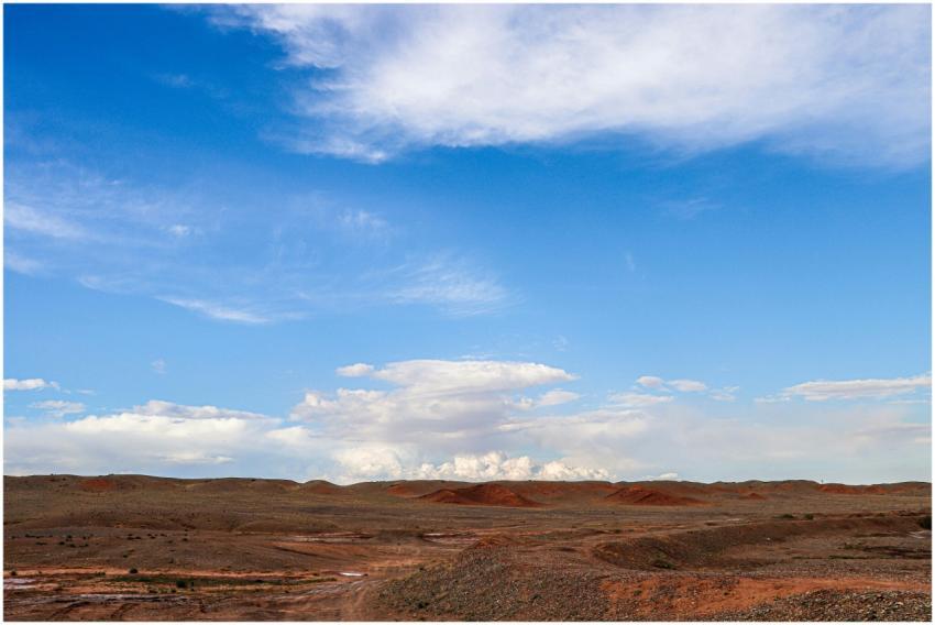 Explore the expansive blue skies and red earth of