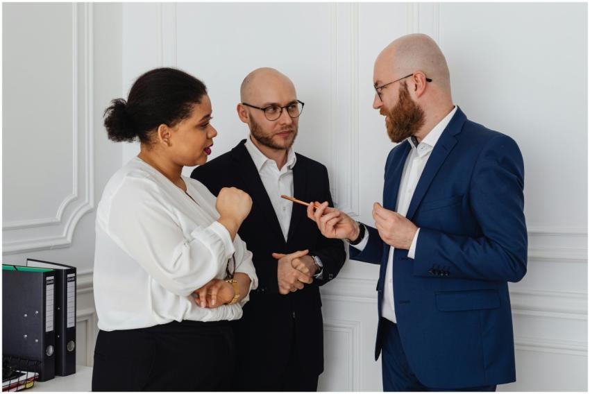 Three professionals engaged in a business discussi