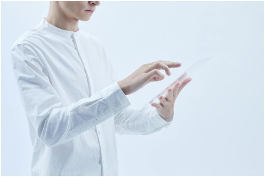 Person interacting with a transparent digital tabl