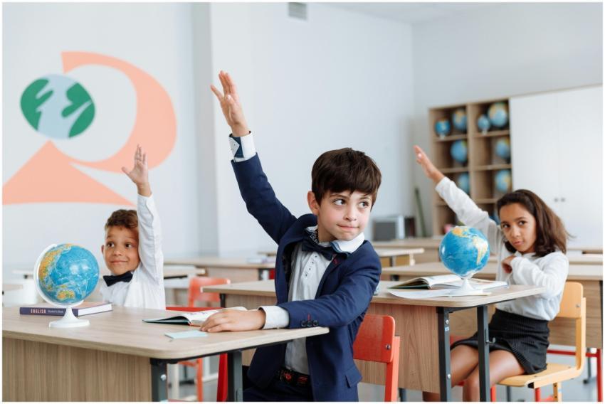 Students in a classroom eagerly raising their hand