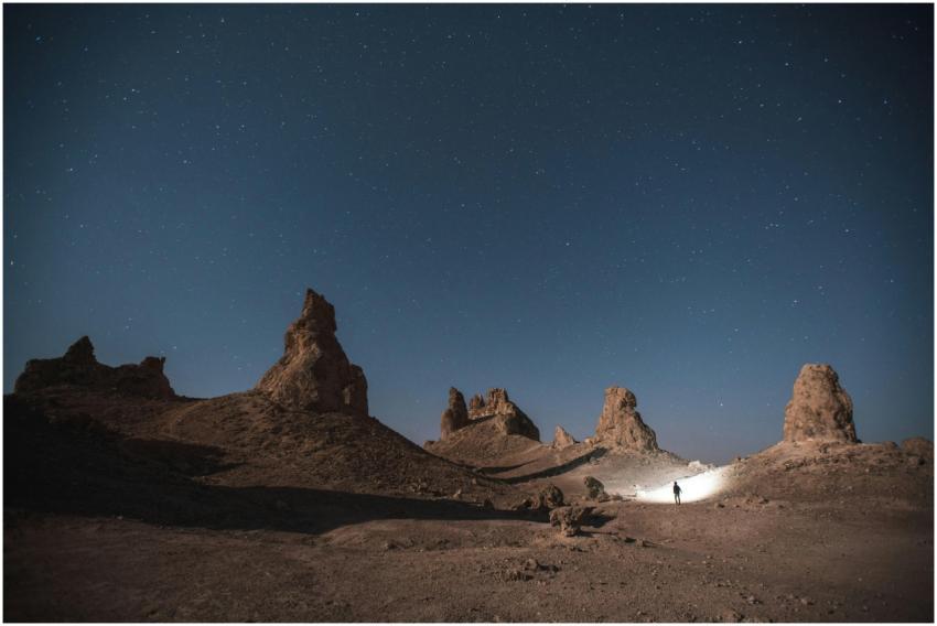 A lone explorer at Trona Pinnacles under a clear s