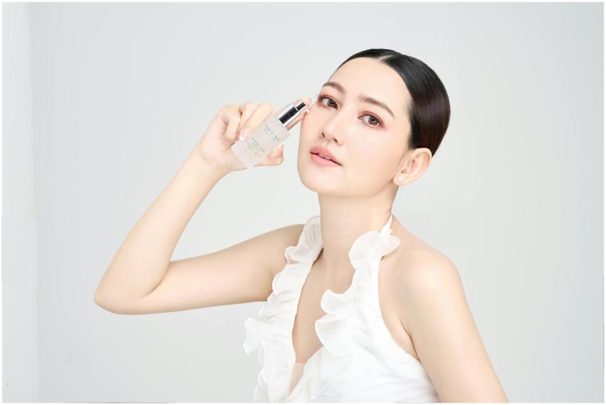 Serene model holding skincare product in modern be