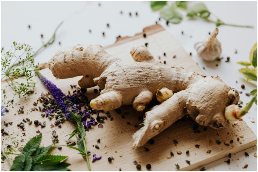 Close-up of fresh ginger root surrounded by spices