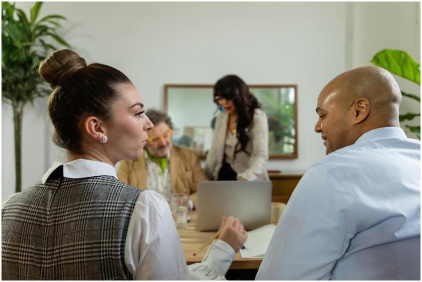 Engaged office team in business discussion around