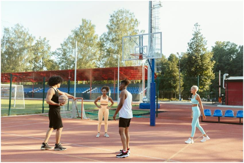 A diverse group of young adults playing basketball