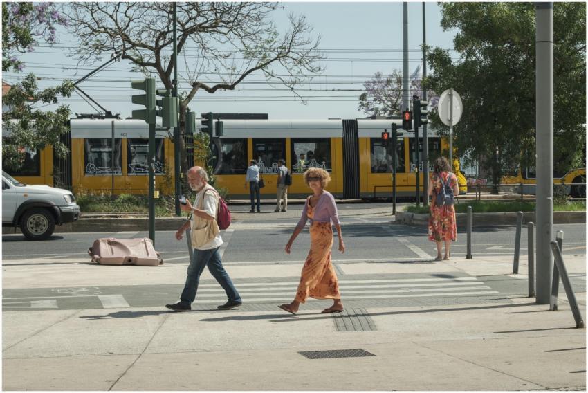 Street scene in Lisbon with pedestrians crossing i