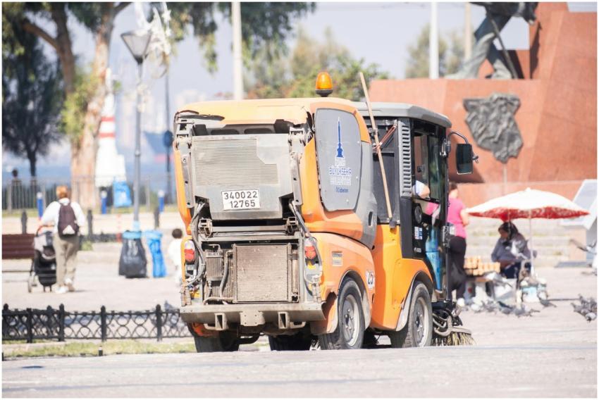 Street cleaning vehicle operating in a public park