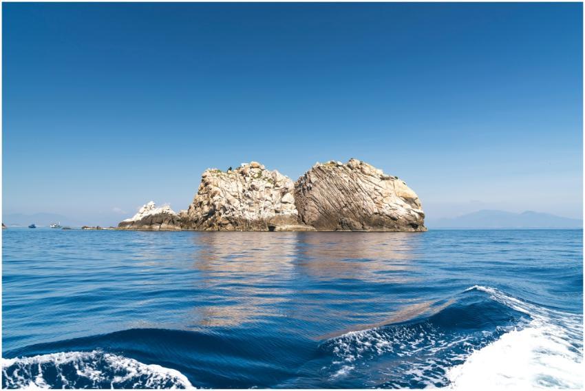 Calm blue ocean with striking rock formations unde