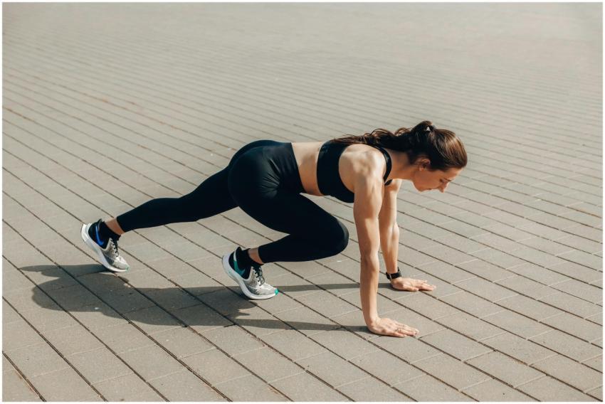 Woman in black sportswear doing an outdoor workout