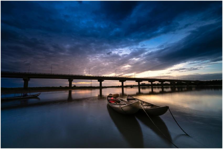 Tranquil twilight scene of boats moored on a river