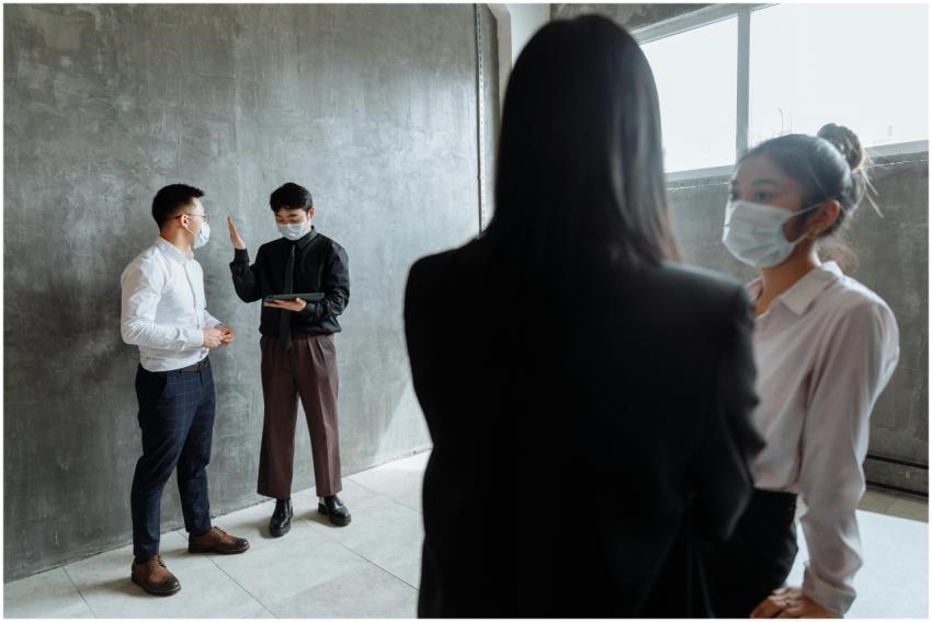 Group of professionals wearing masks, discussing b