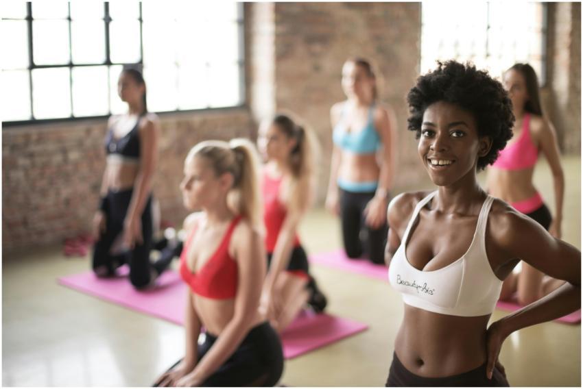 Group of diverse women in activewear doing yoga in