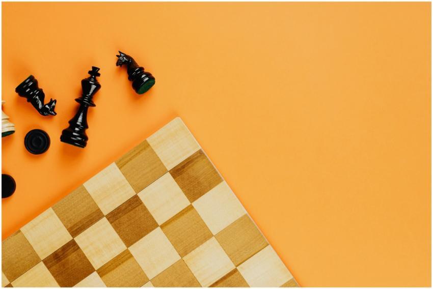 Flat lay of scattered chess pieces and board on a