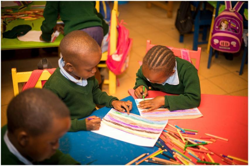 Young children engaged in colorful drawing activit