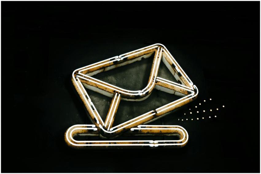 A glowing neon envelope symbol against a black bac
