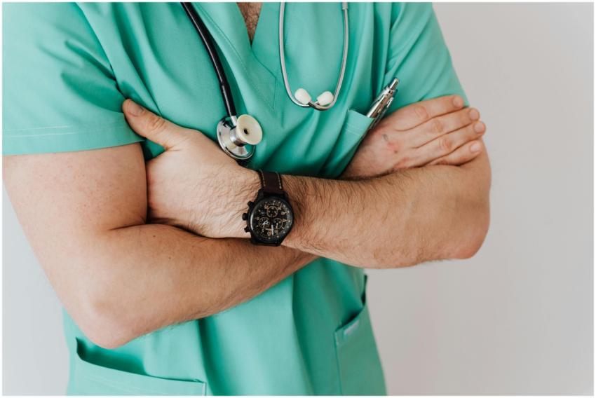 Close-up of a male doctor in scrubs with crossed a