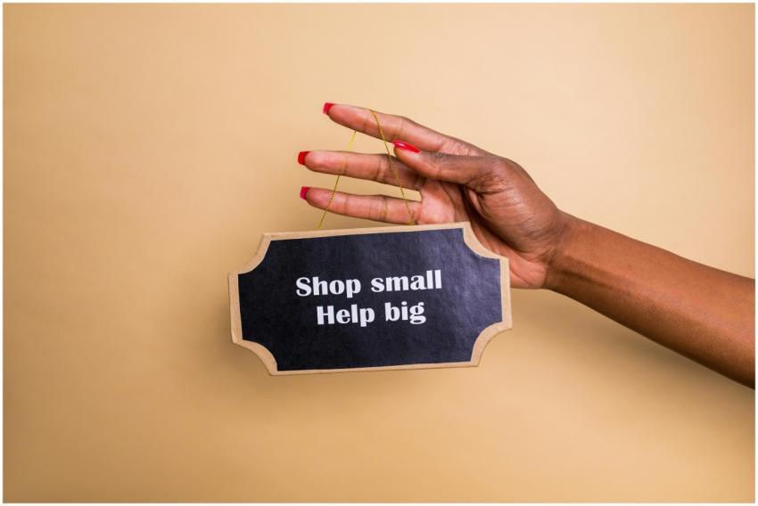 Close-up of a hand holding an inspiring sign encou