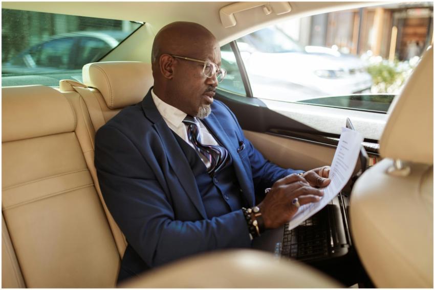 Mature businessman in a suit reviewing papers insi